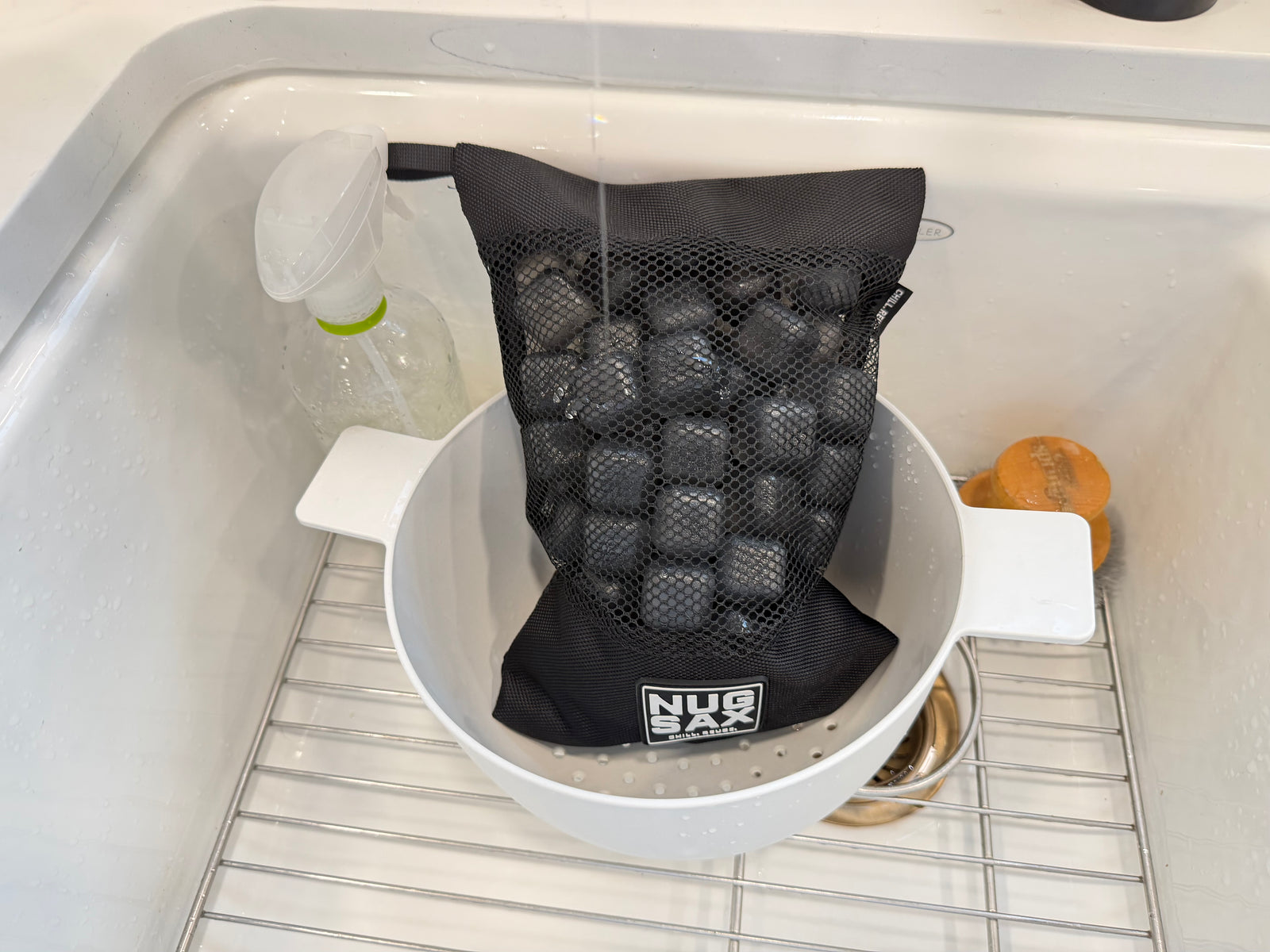 NUGSAX reusable ice cubes inside the mesh bag in a colander