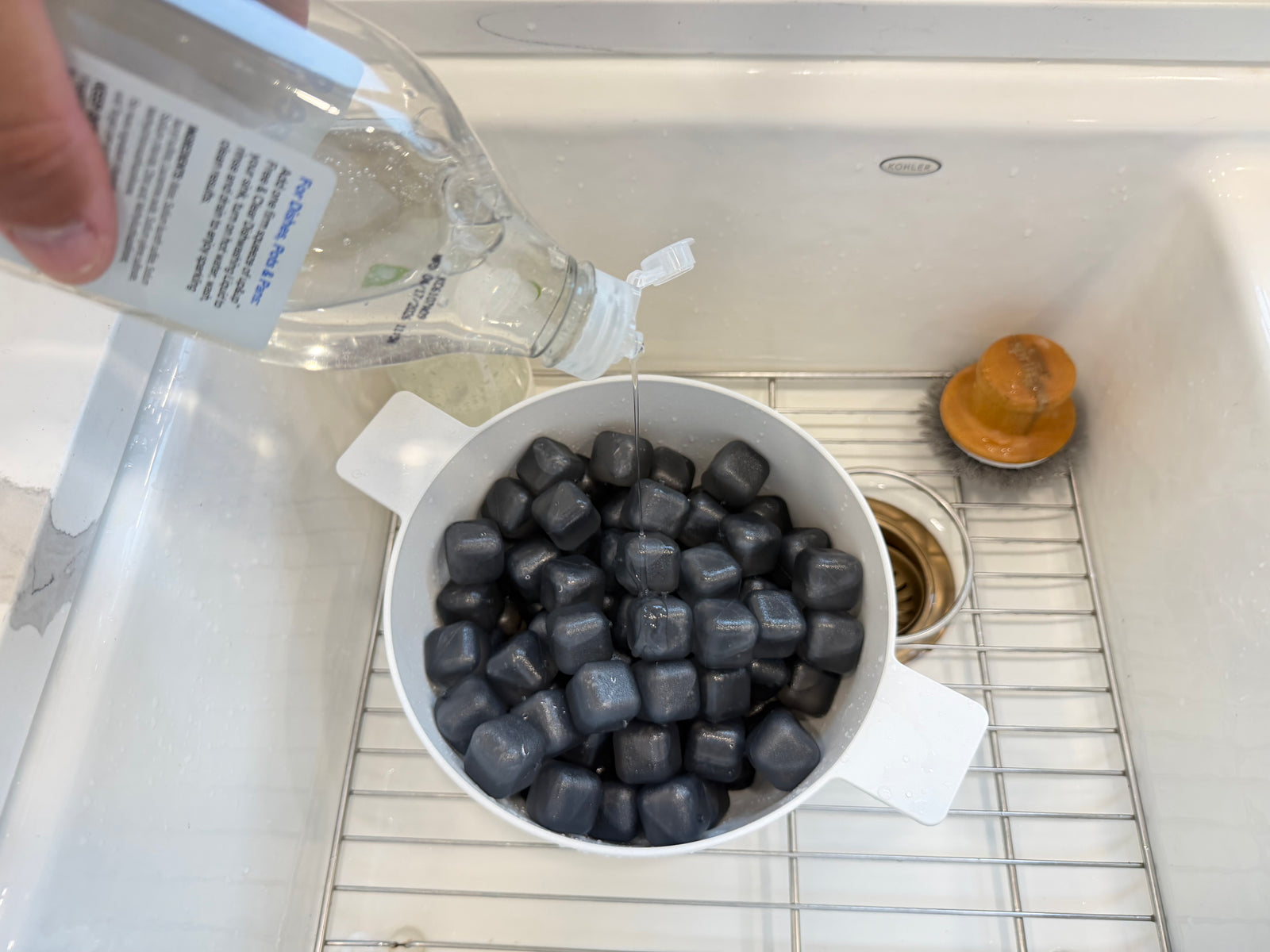 Dish soap being applied to NUGSAX reusable ice cubes