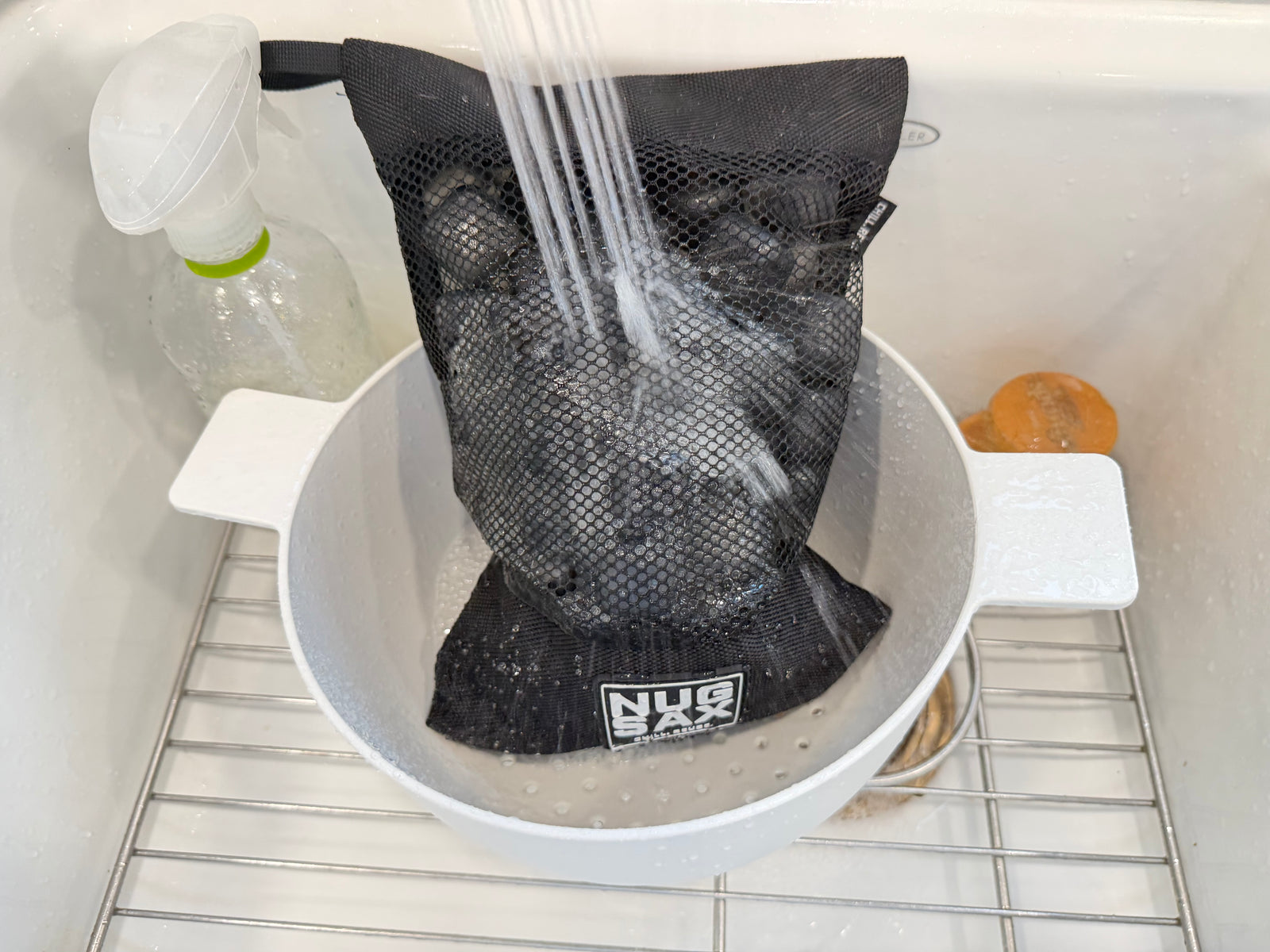NUGSAX reusable ice cubes being rinsed inside the mesh bag