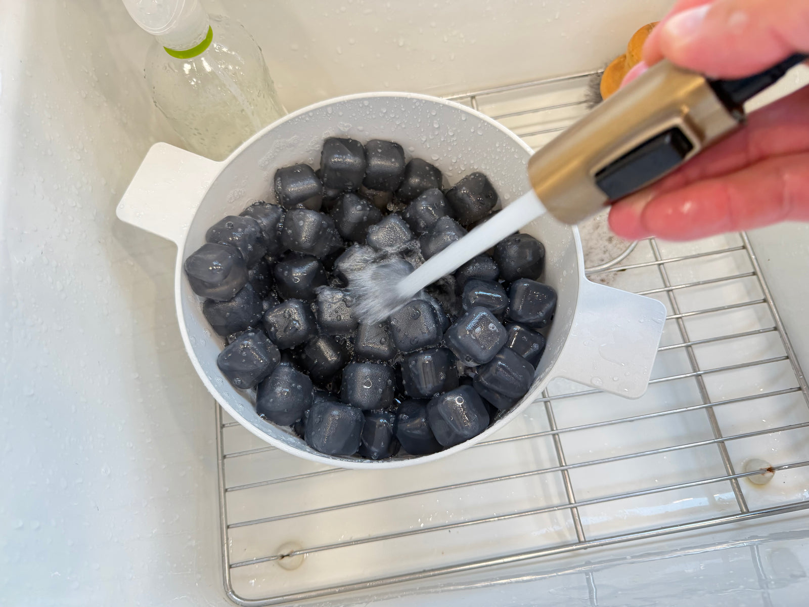 NUGSAX reusable ice cubes being rinsed with clean water