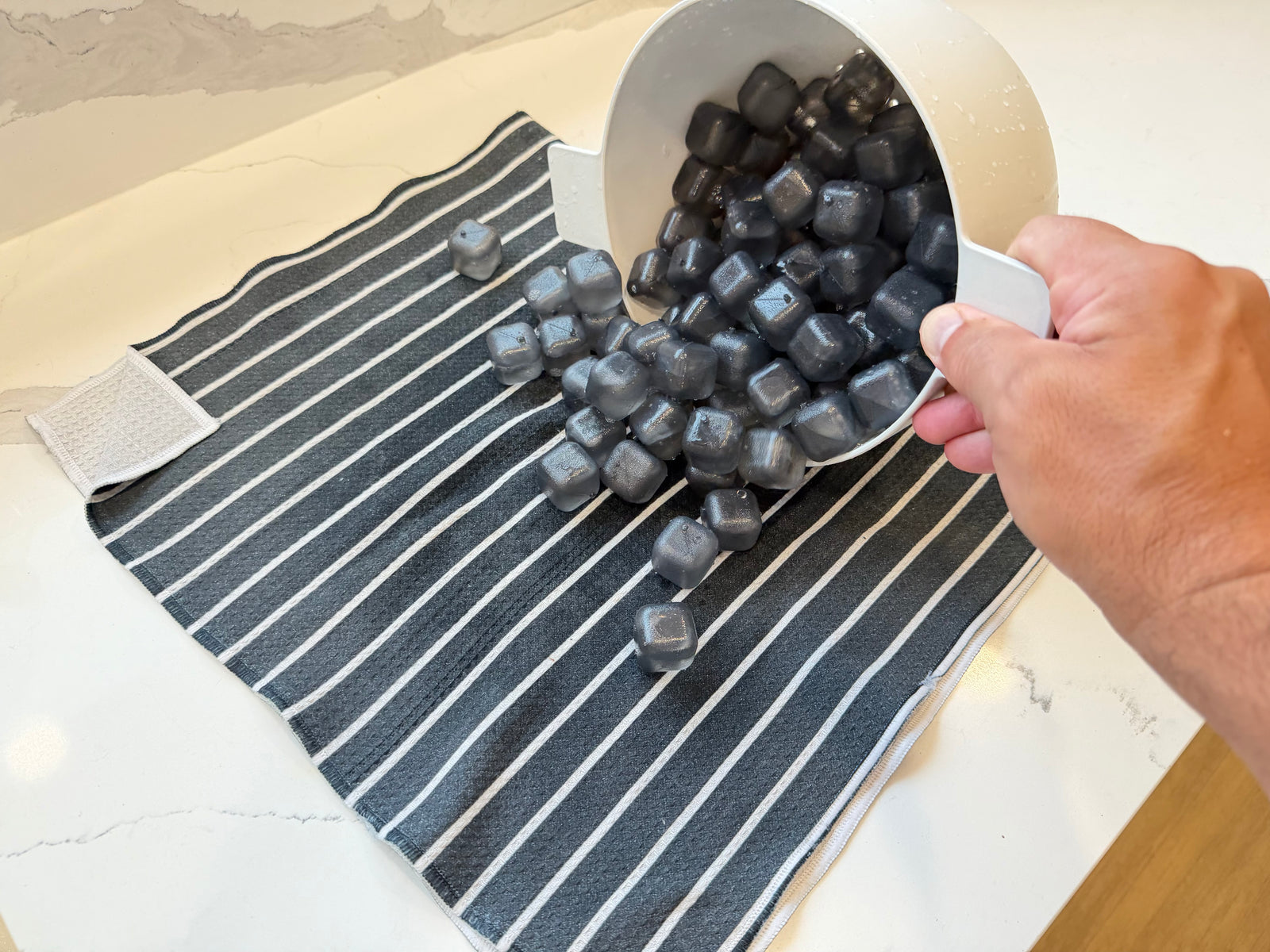 Clean NUGSAX reusable ice cubes spread across a towel to air dry